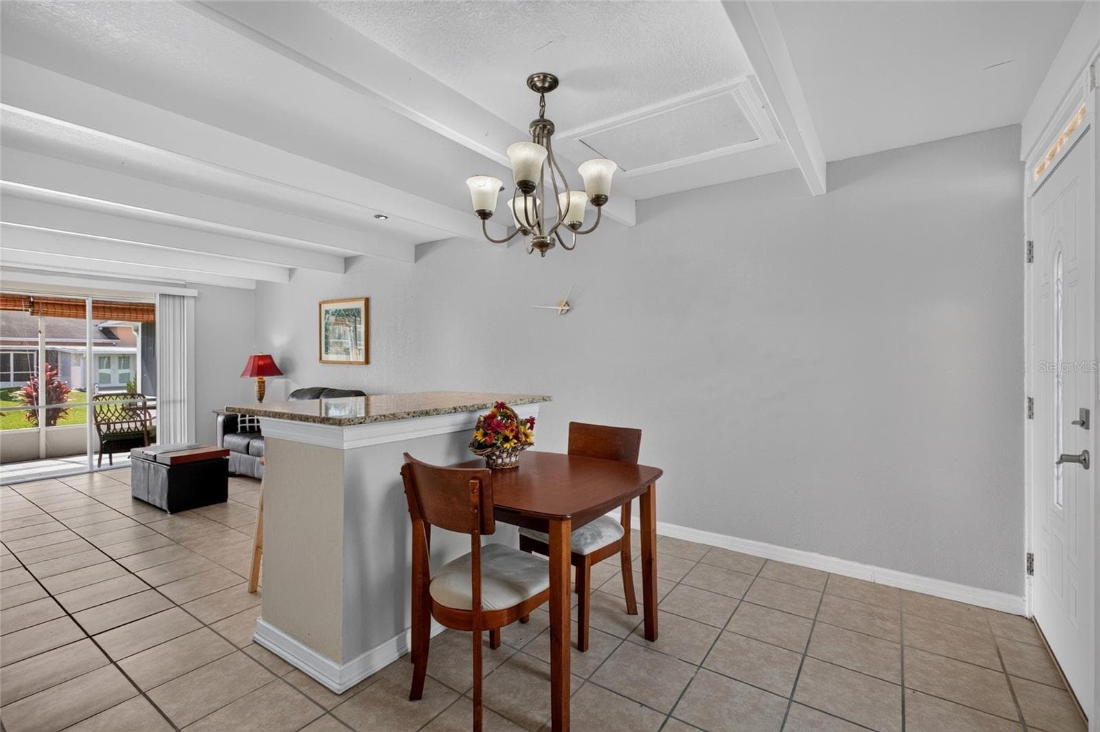 Open floor plan. High ceilings. Lots of natural light filters into the home. Granite on the breakfast bar and ceramic tile flooring. - 4409 CLUB CIR, LAKE WALES