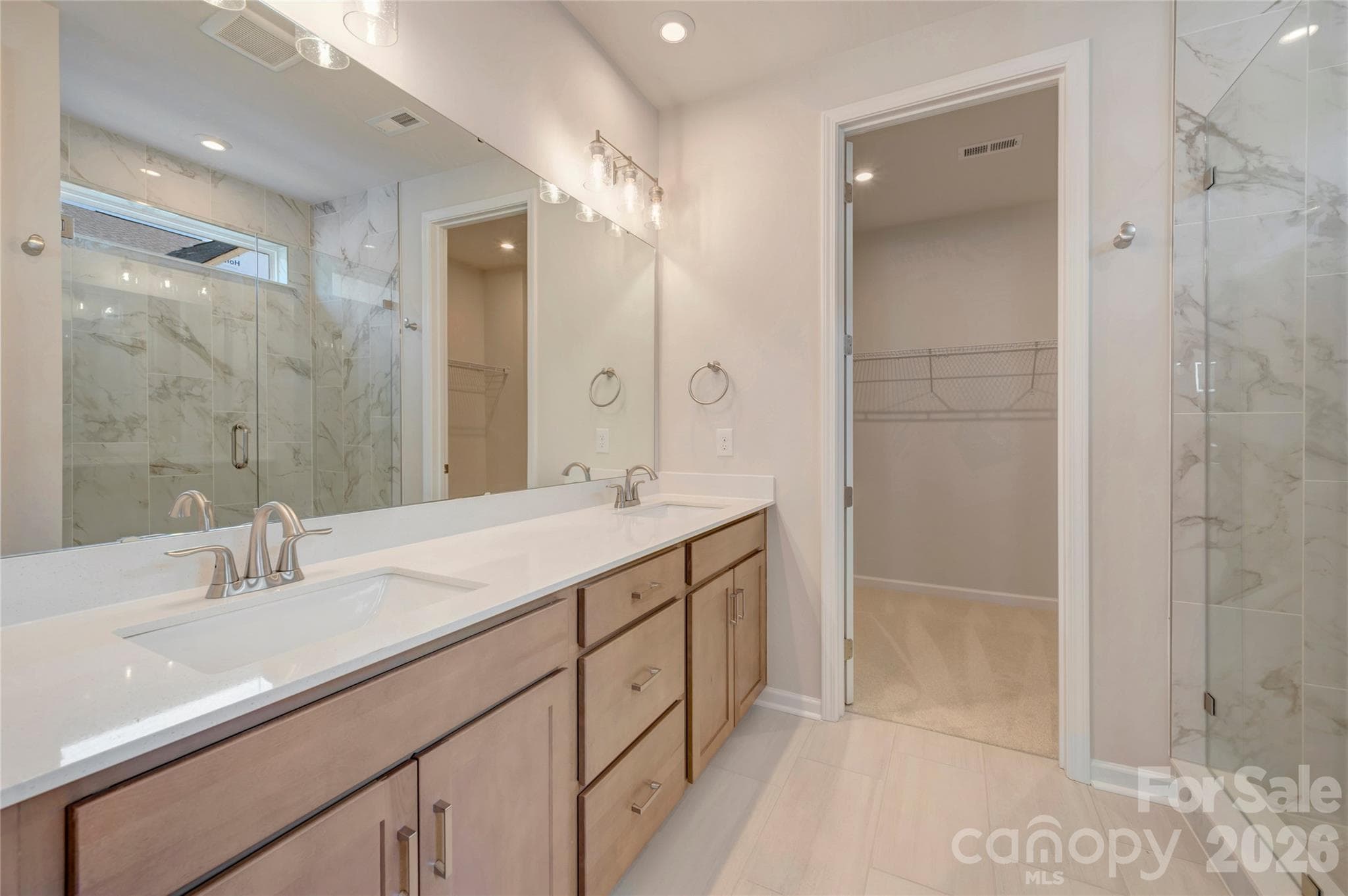 Dual vanity primary bathroom with a tiled walk-in shower - Charlotte