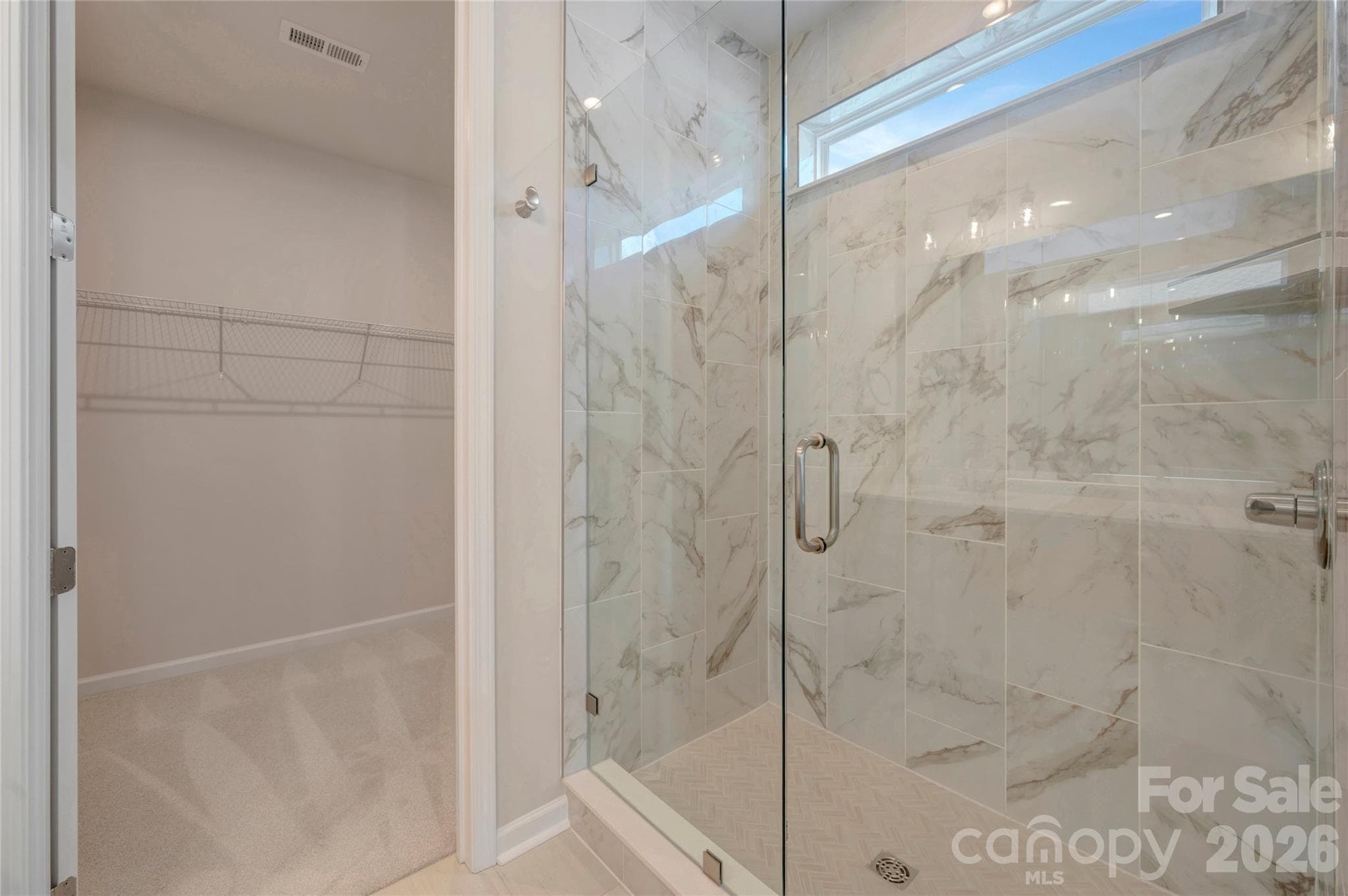 Dual vanity primary bathroom with a tiled walk-in shower - Charlotte