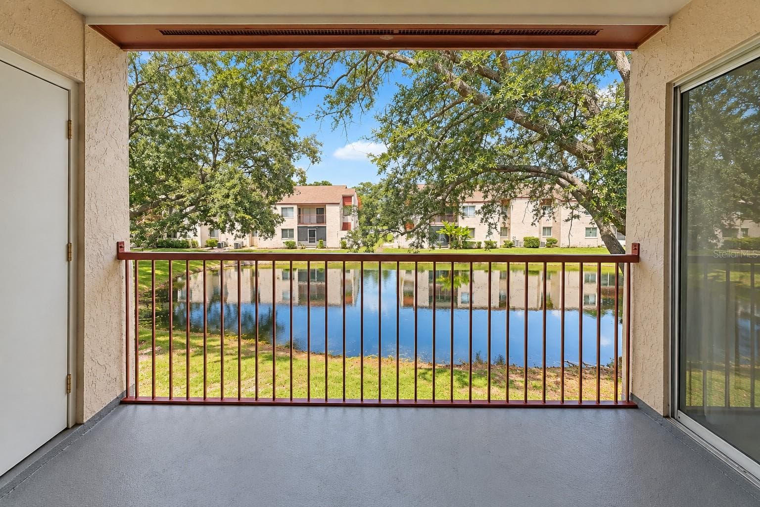 Tranquil pond view from balcony. Exterior storage room at left. - 2527 CITRUS CLUB LN #3904, ORLANDO