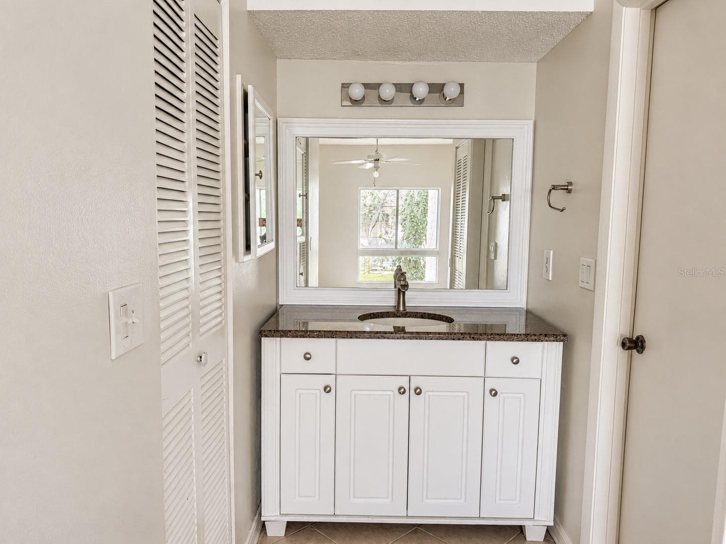 Updated primary vanity area; walk-in closet at left. Shower and toilet area at right. - 2527 CITRUS CLUB LN #3904, ORLANDO