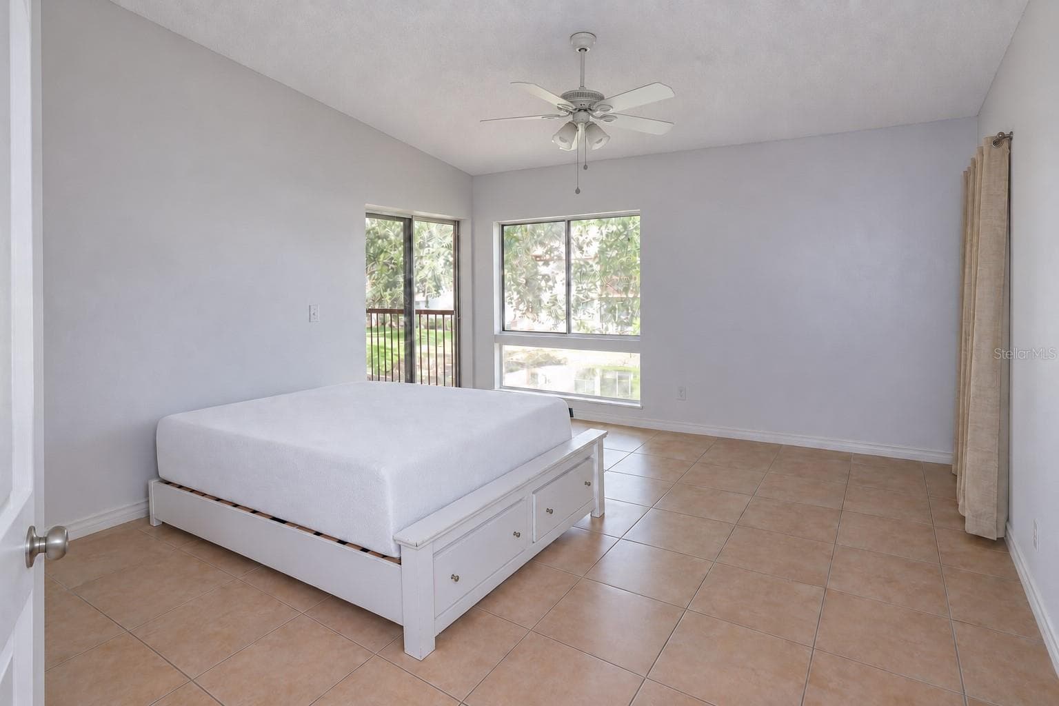 Bedroom 2 with pond view and slider access to balcony. One closet at right; a second one left of the entry door. - 2527 CITRUS CLUB LN #3904, ORLANDO