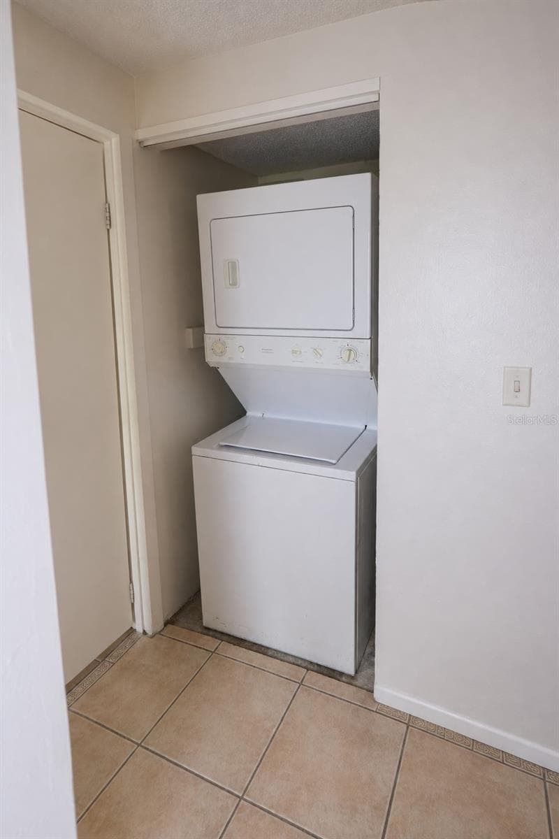 Stacked washer and dryer in laundry closet. - 2527 CITRUS CLUB LN #3904, ORLANDO