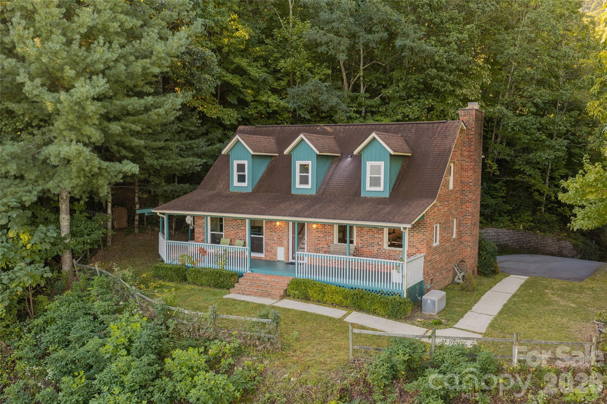 Aerial showing back of house along with driveway. - 126 Wildflower Cove Drive, Swannanoa