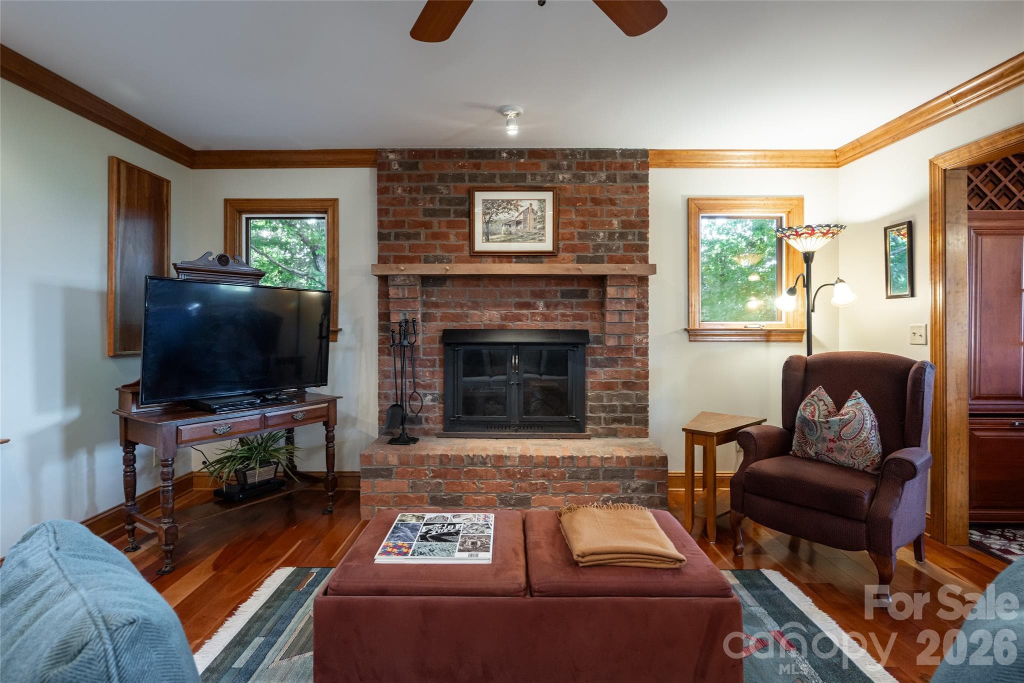 A brick fireplace serves as the centerpiece of the living room - 126 Wildflower Cove Drive, Swannanoa