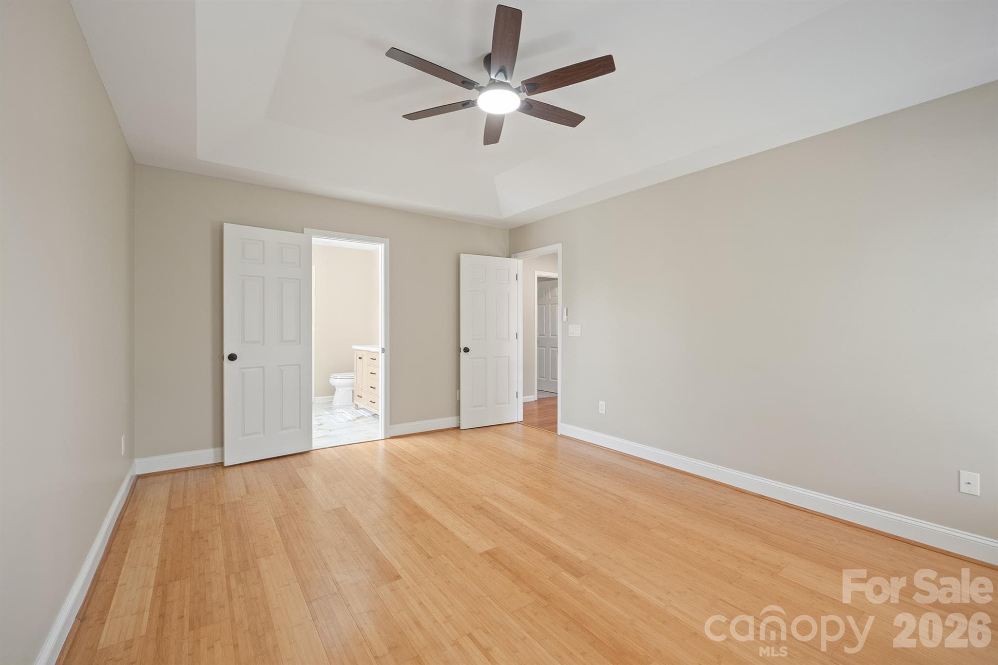 Primary bedroom with bamboo flooring and new paint - 110 Fox Den Circle, Statesville