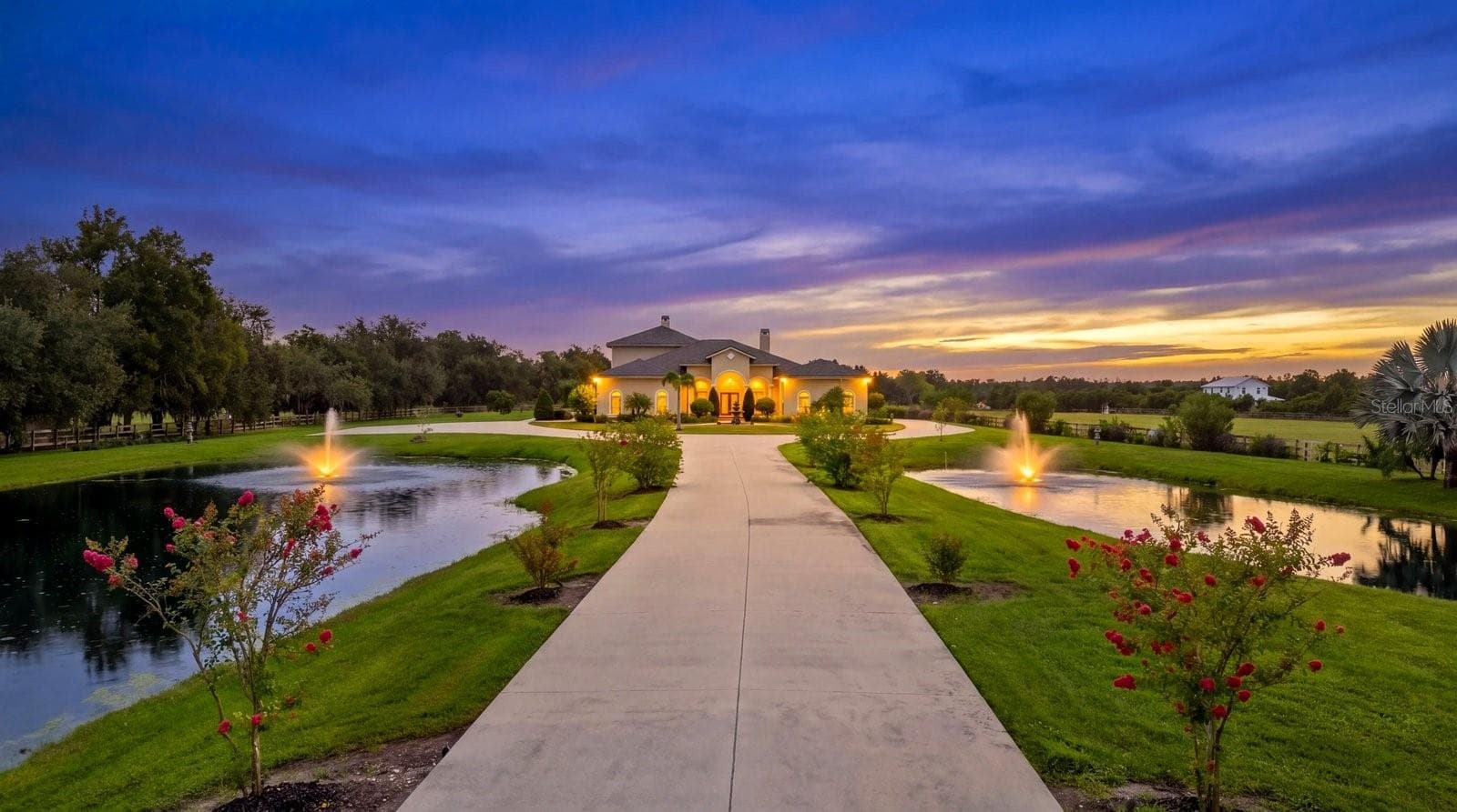 The young crepe myrtle trees will soon grow into a wall of color as you cruise the long drive to your new home - 520 RYE RD NE, BRADENTON