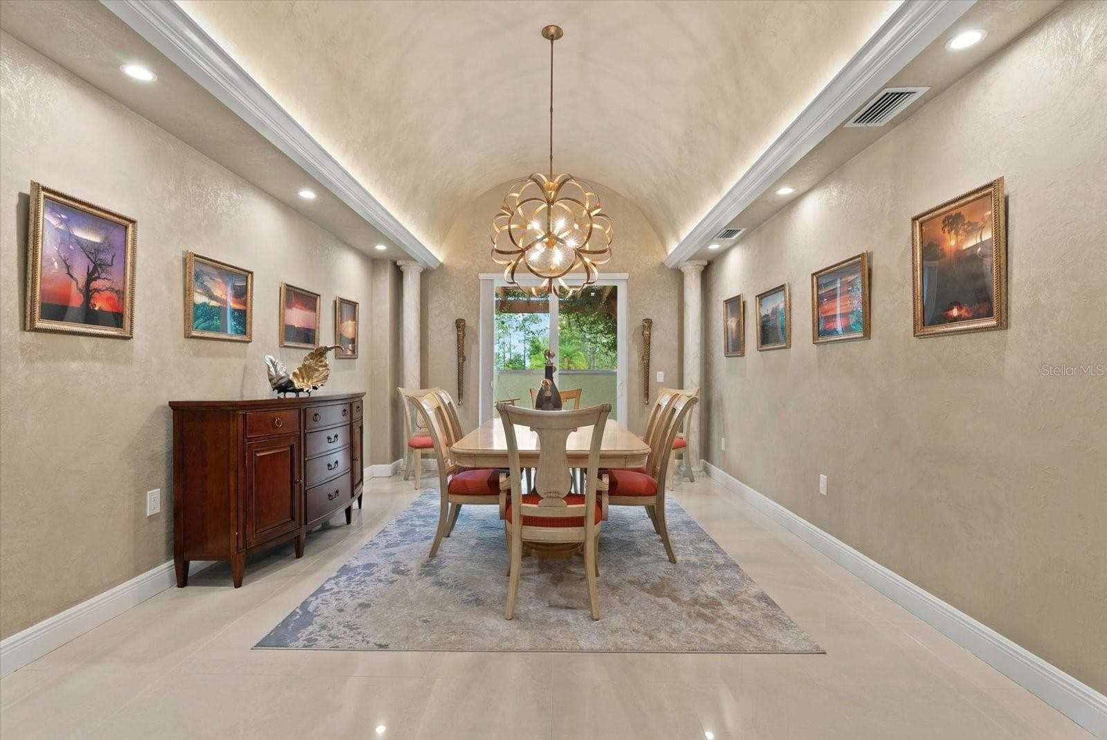The dining room features a coved ceiling, fine millwork, and french doors leading to a side patio - 520 RYE RD NE, BRADENTON