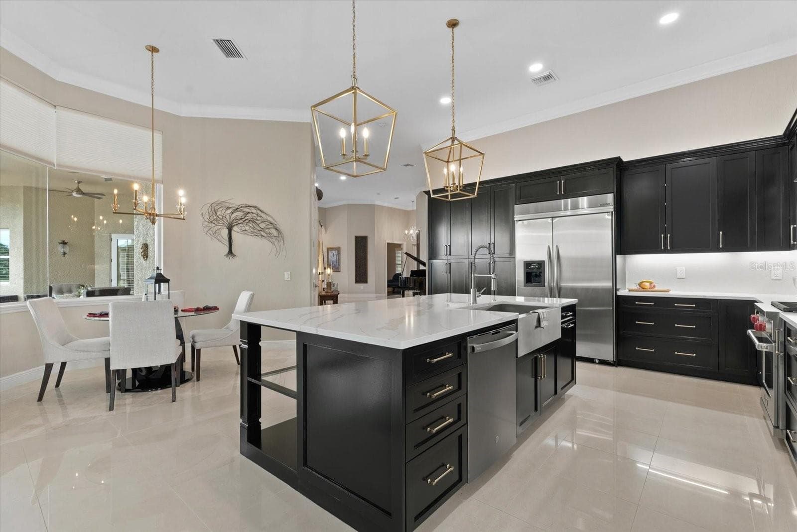 A breakfast nook sits just off the kitchen, overlooking the pool deck - 520 RYE RD NE, BRADENTON