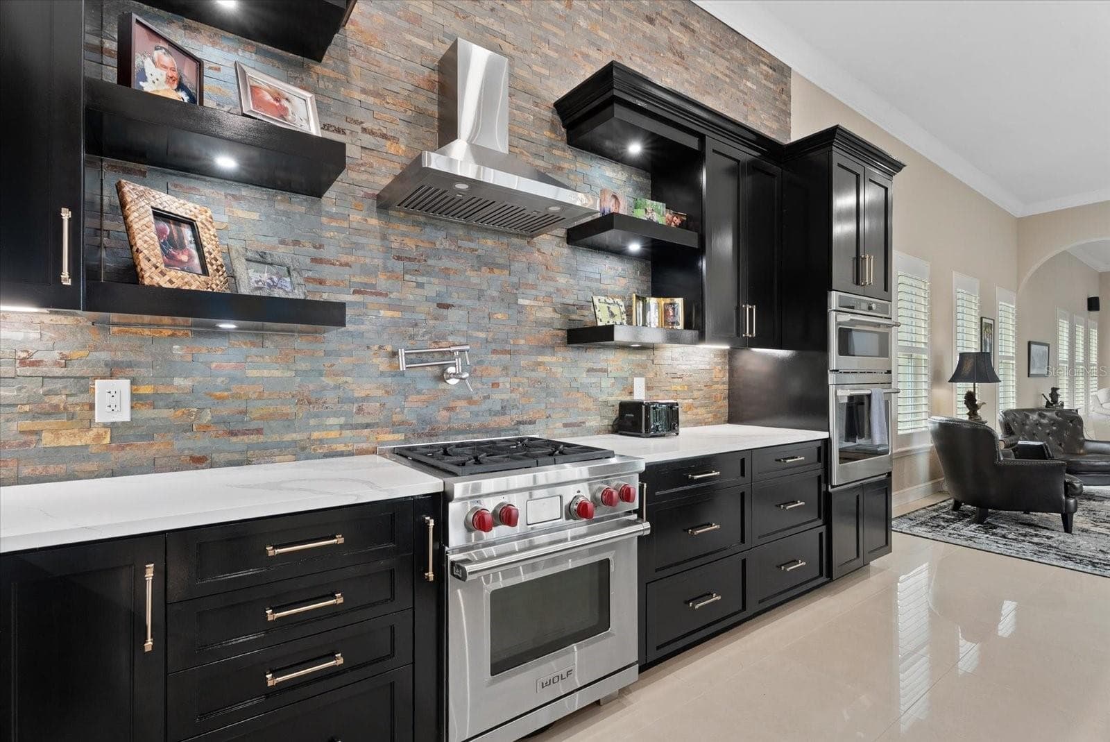 The home offers a gas range/cooktop, built-in oven and microwave with marble countertops - 520 RYE RD NE, BRADENTON