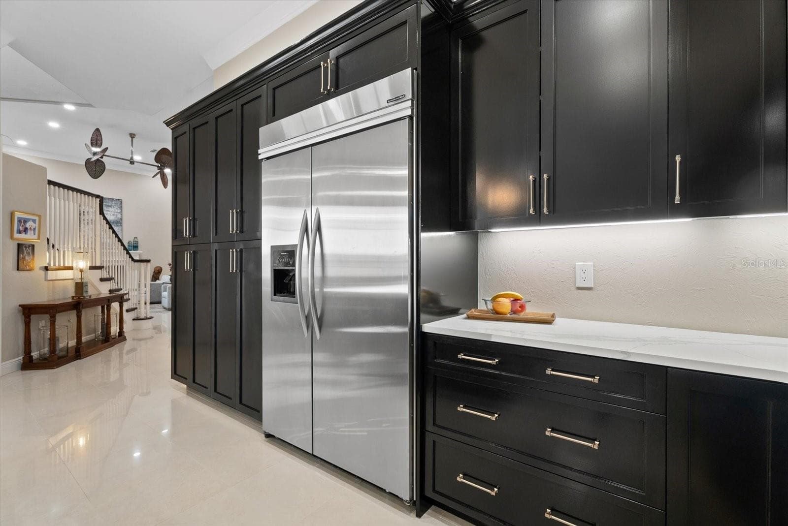 High end stainless steel appliances and a bank of custom cabinets are shown. There is also a walk-in pantry and two other closets accessible to the kitchen and dining room - 520 RYE RD NE, BRADENTON