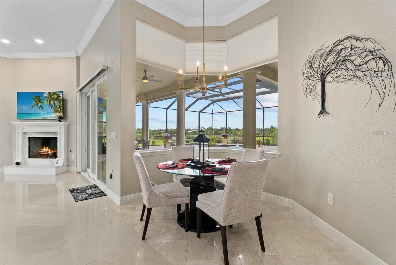 The breakfast nook is surrounded by aquarium glass windows looking out on the pool deck and pastures - 520 RYE RD NE, BRADENTON