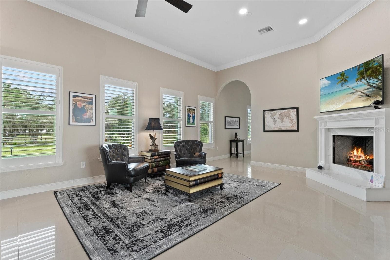The family room is surrounded by windows with plantation shutters as well as sliders leading to the pool deck - 520 RYE RD NE, BRADENTON