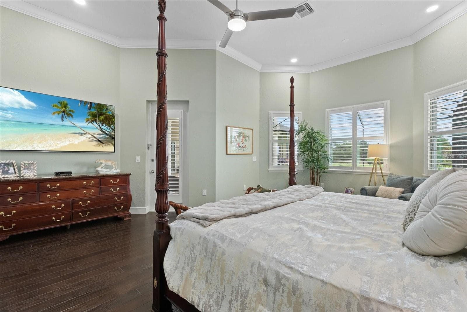 The primary suite is adorned with plantation shutters and recessed lighting - 520 RYE RD NE, BRADENTON