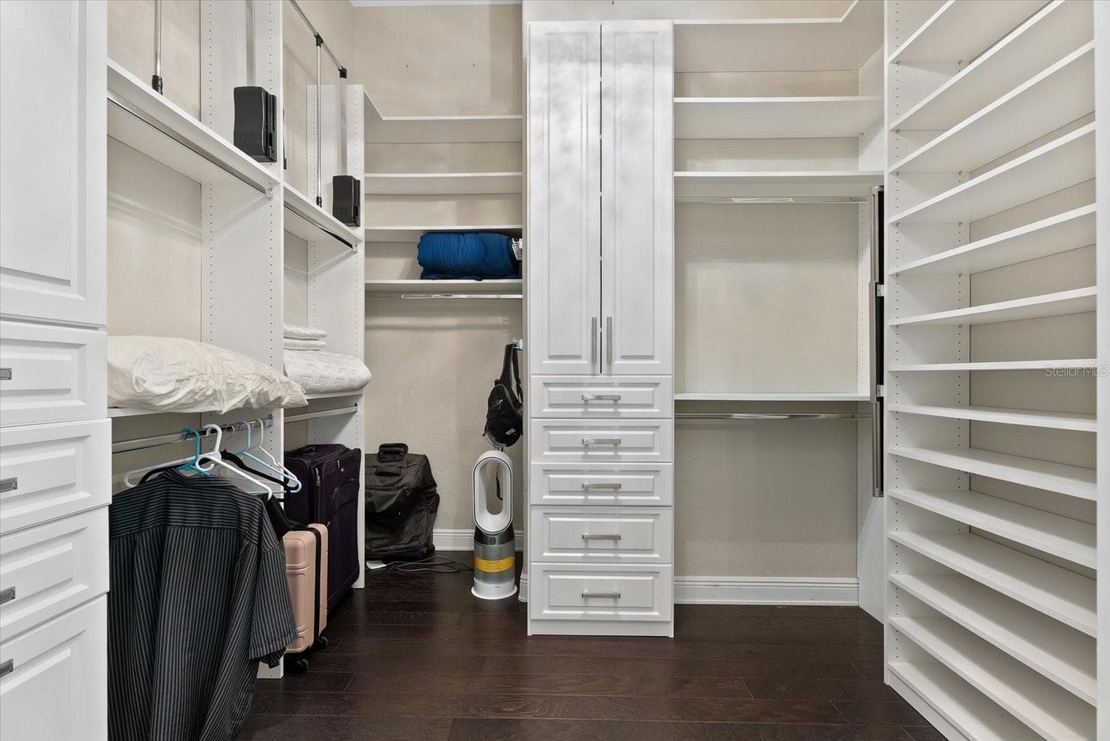 The two walk-in closets feature custom cabinets and shelving - 520 RYE RD NE, BRADENTON