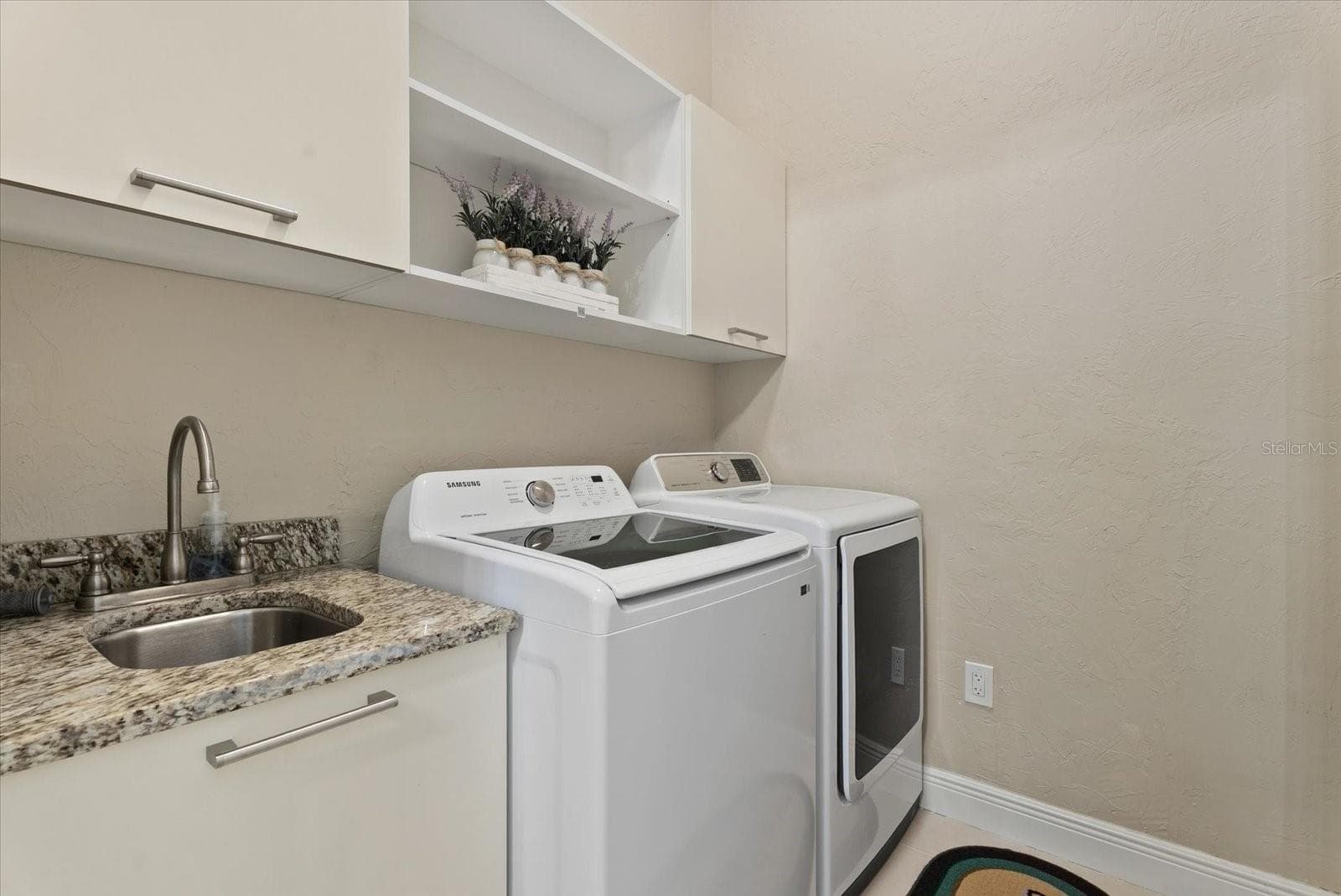 The laundry room is located on the first floor, just off the bonus room - 520 RYE RD NE, BRADENTON