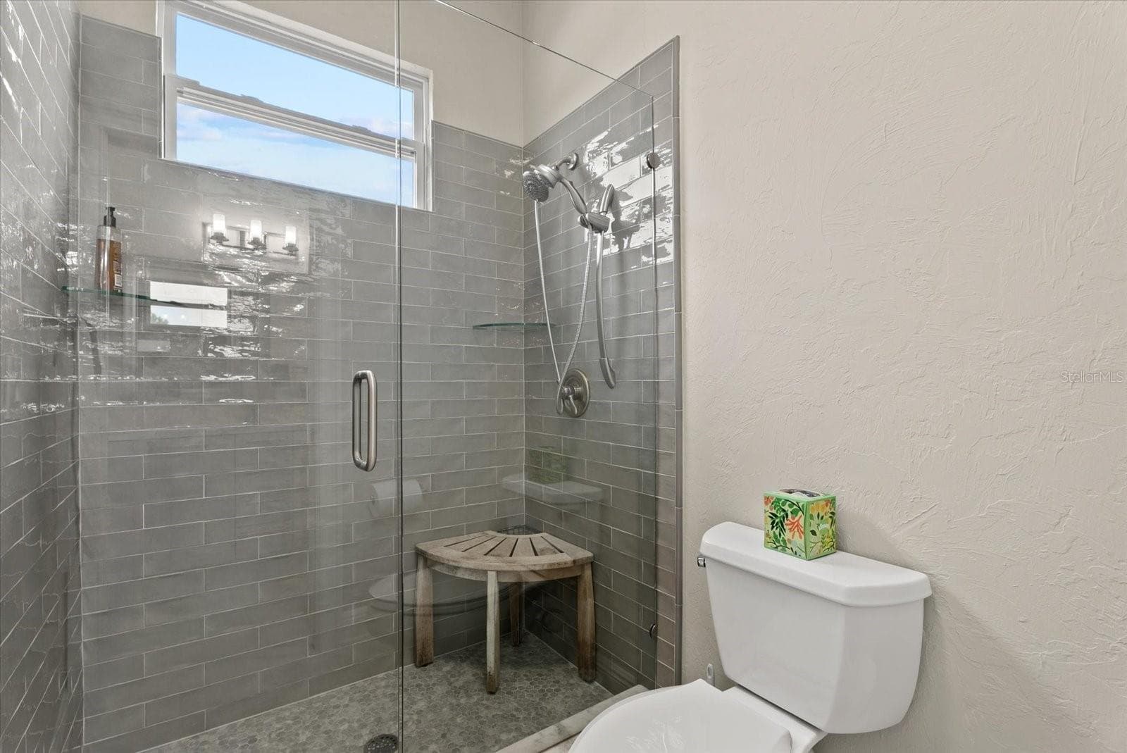 The toilet and shower area are closed off from the shared sink area of the Jack and Jill bathroom upstairs - 520 RYE RD NE, BRADENTON