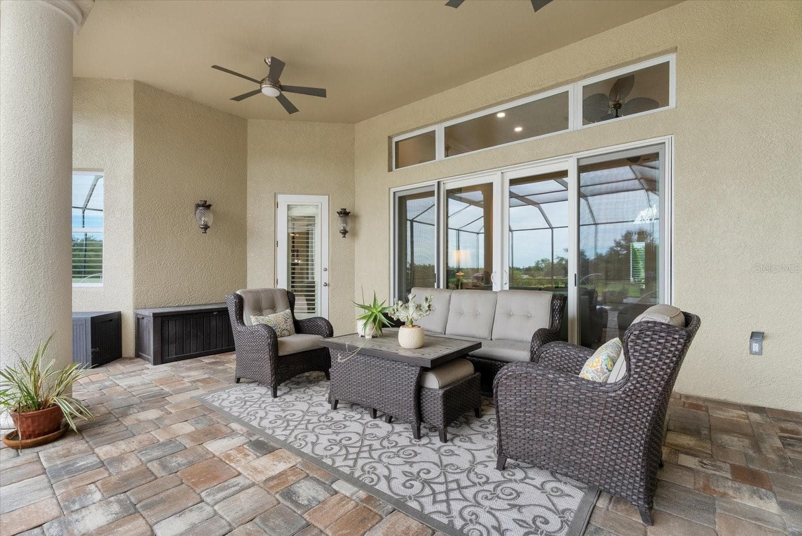 Back downstairs on the pool deck you'll find two separate lounges. This one is off the living room and primary suite - 520 RYE RD NE, BRADENTON