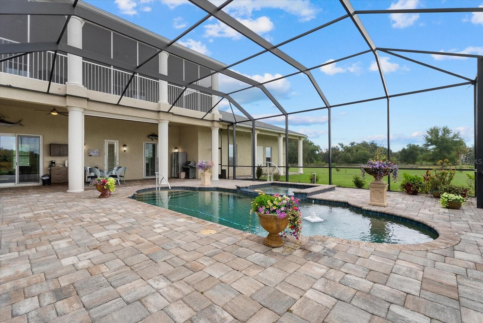 This view shows the upper lanai, and the lounge off the family room. The door shown leads to a half bath - 520 RYE RD NE, BRADENTON