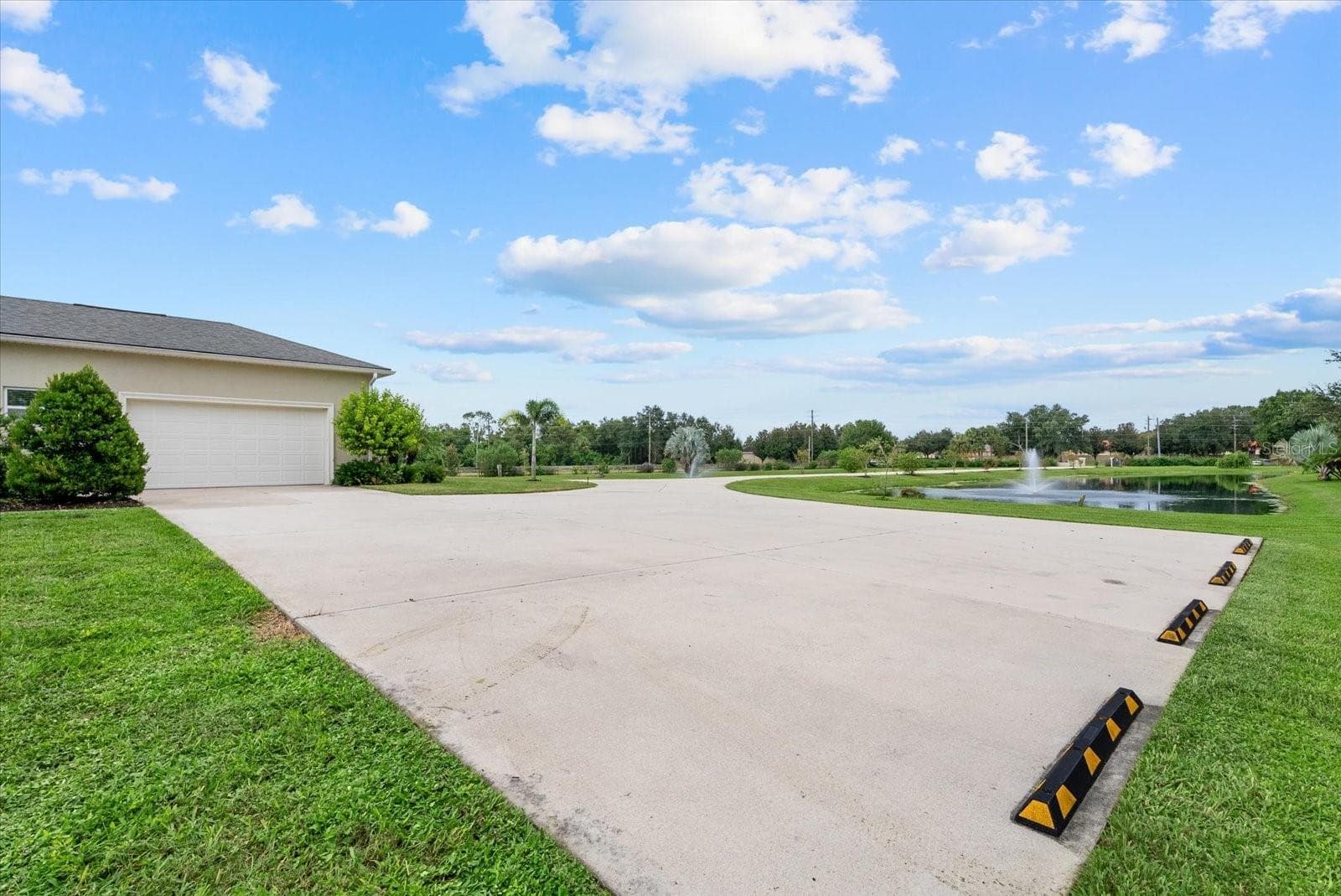 The extended parking pad on the south side of the home - 520 RYE RD NE, BRADENTON
