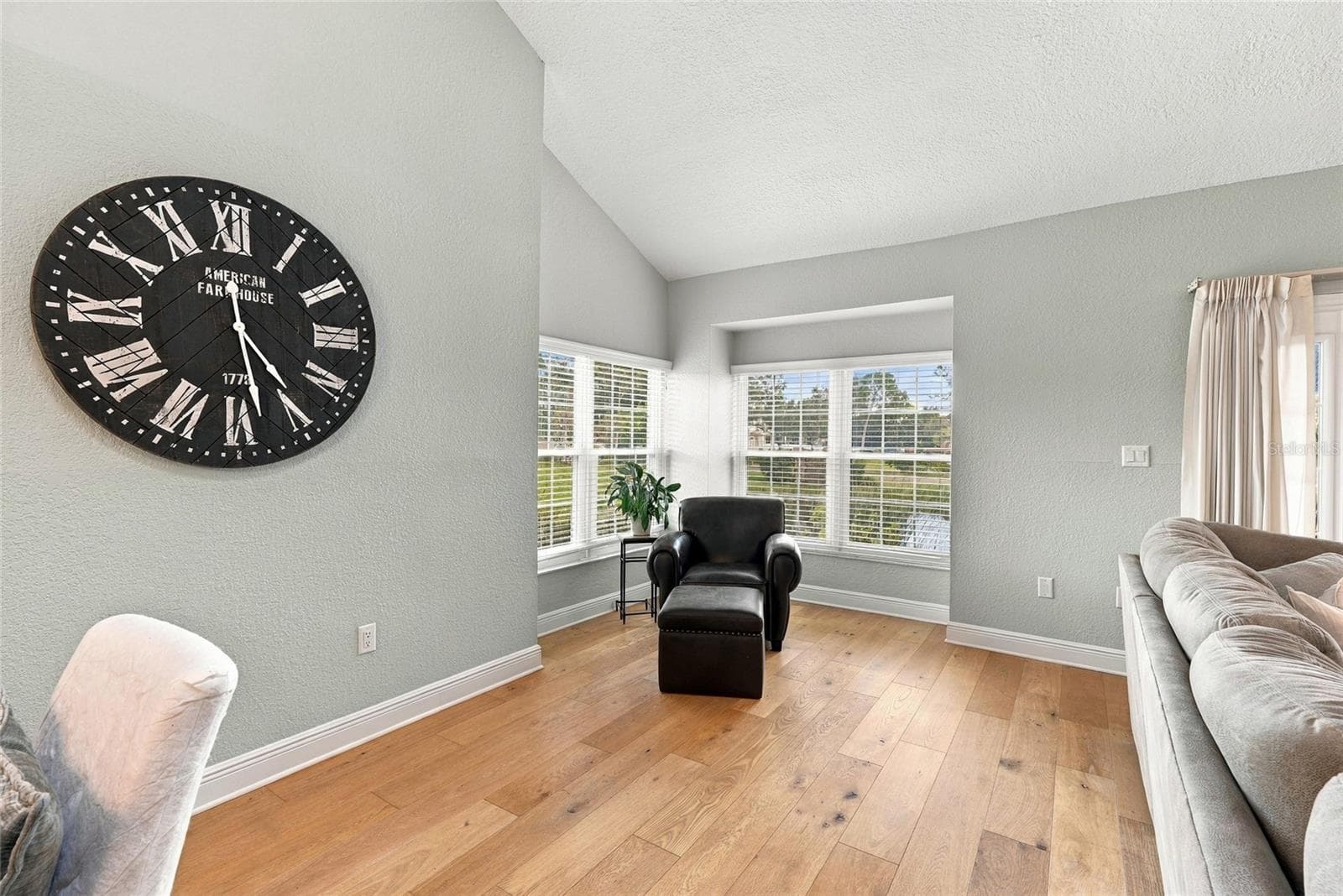 A cozy, light-filled corner creates the perfect spot to read, relax, and take in the tranquil pond views. - 629 SEGOVIA CT NE #405, ST PETERSBURG