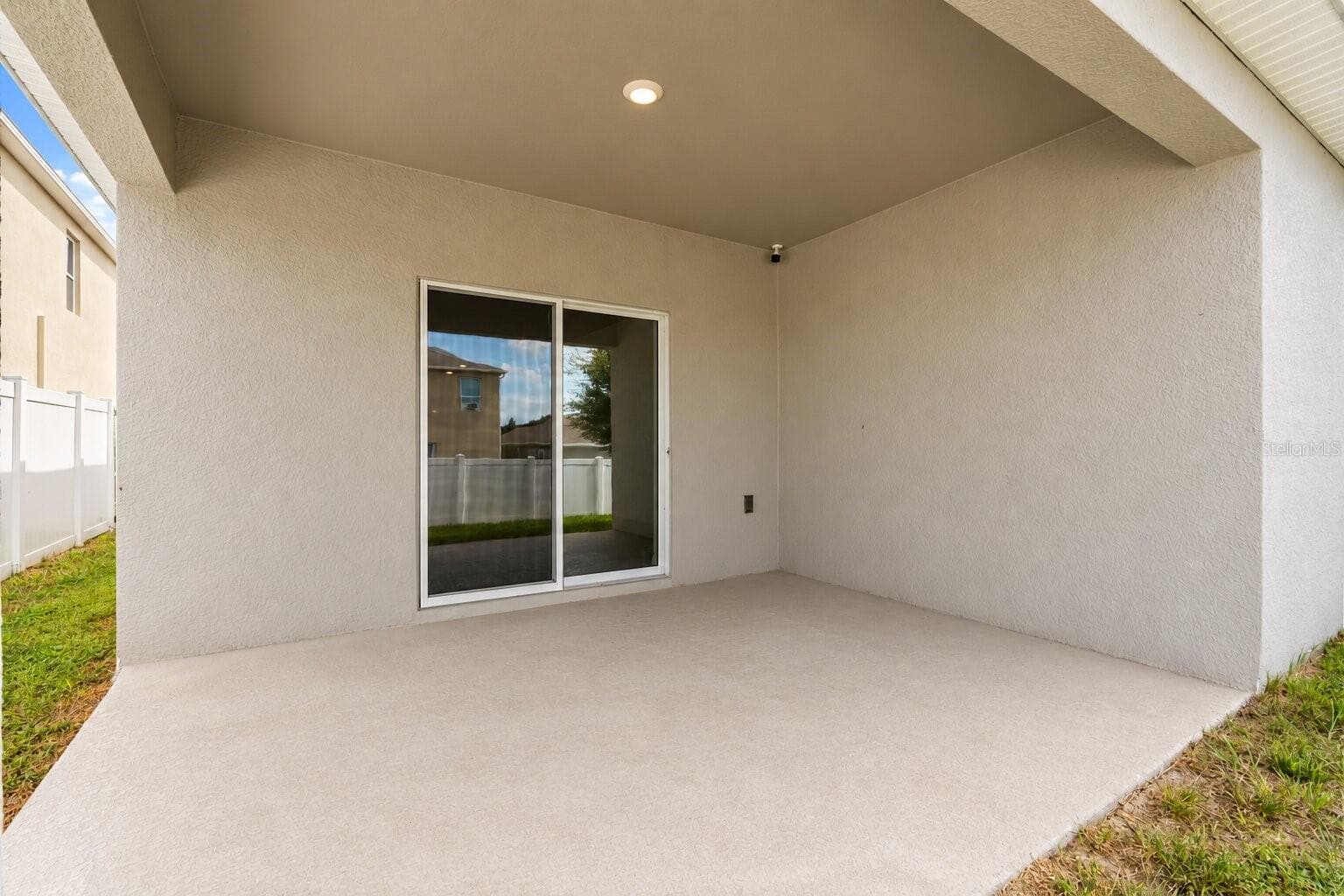 Covered rear lanai offering a shaded space for outdoor dining or relaxing. - 3658 CASPIAN ST, LEESBURG