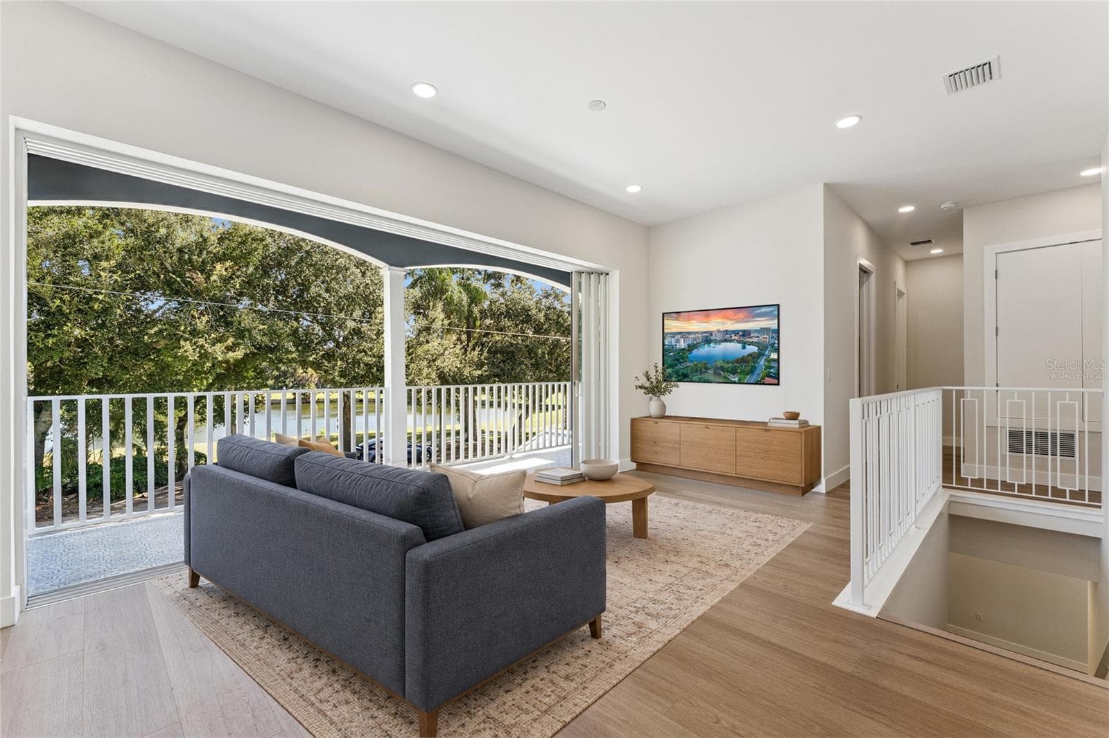 Virtually Staged - The loft offers natural light, recessed lighting, and a view of the staircase. - 3456 FAIRWAY LN, ORLANDO