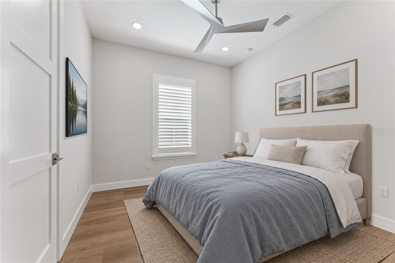Virtually Staged - This bedroom features a white ceiling fan, shuttered window, and light finishes. - 3456 FAIRWAY LN, ORLANDO