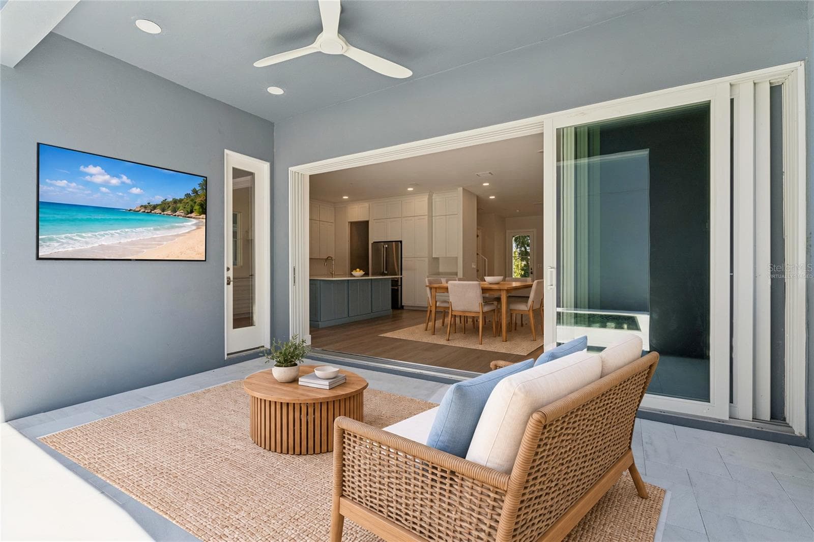 Virtually Staged - The covered rear patio has a ceiling fan and sliding doors to the main living area. - 3456 FAIRWAY LN, ORLANDO