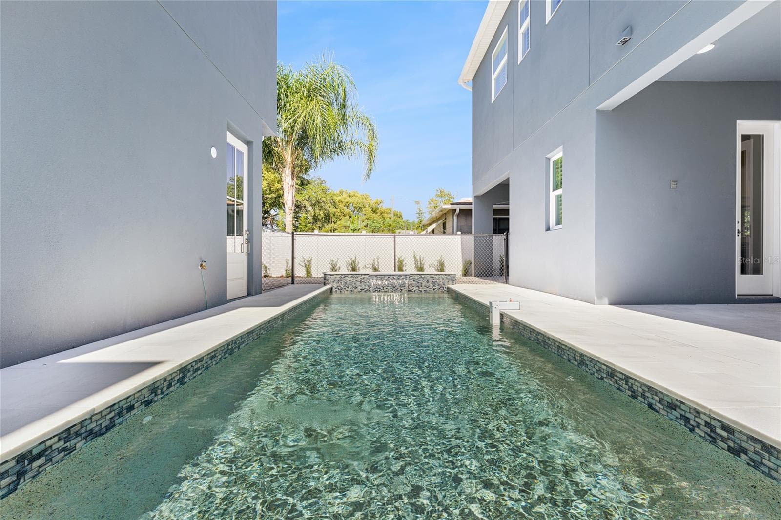 A lengthwise pool view shows the surrounding paved deck and the relationship to the home. - 3456 FAIRWAY LN, ORLANDO