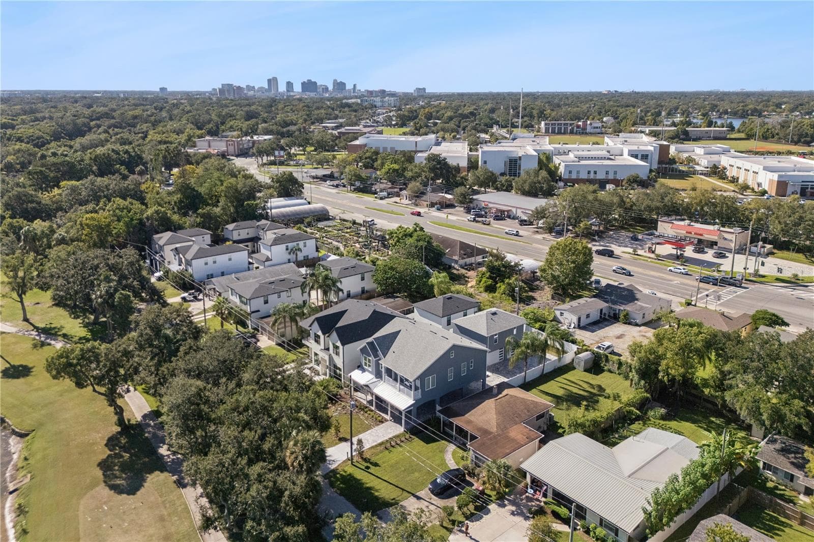 An aerial view shows the home and surrounding neighborhood of College Park with Orlando in the background. - 3456 FAIRWAY LN, ORLANDO