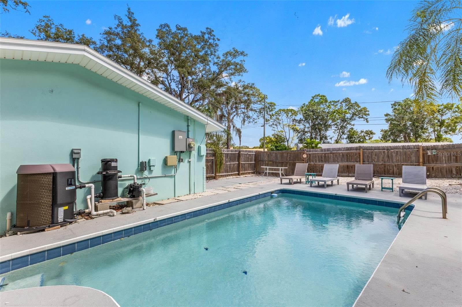 Heated pool with a new pool pump and heater added in 2025—ready for year-round Florida living. - 201 SOUTH ST, PALM HARBOR