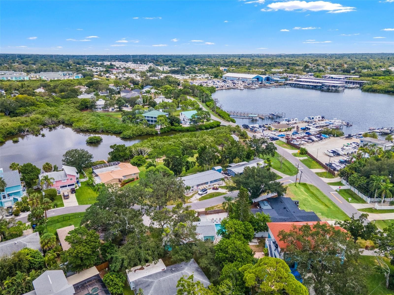 Aerial view showcasing the home’s location in Ozona, surrounded by marinas, waterways, and the area’s coastal setting. - 201 SOUTH ST, PALM HARBOR
