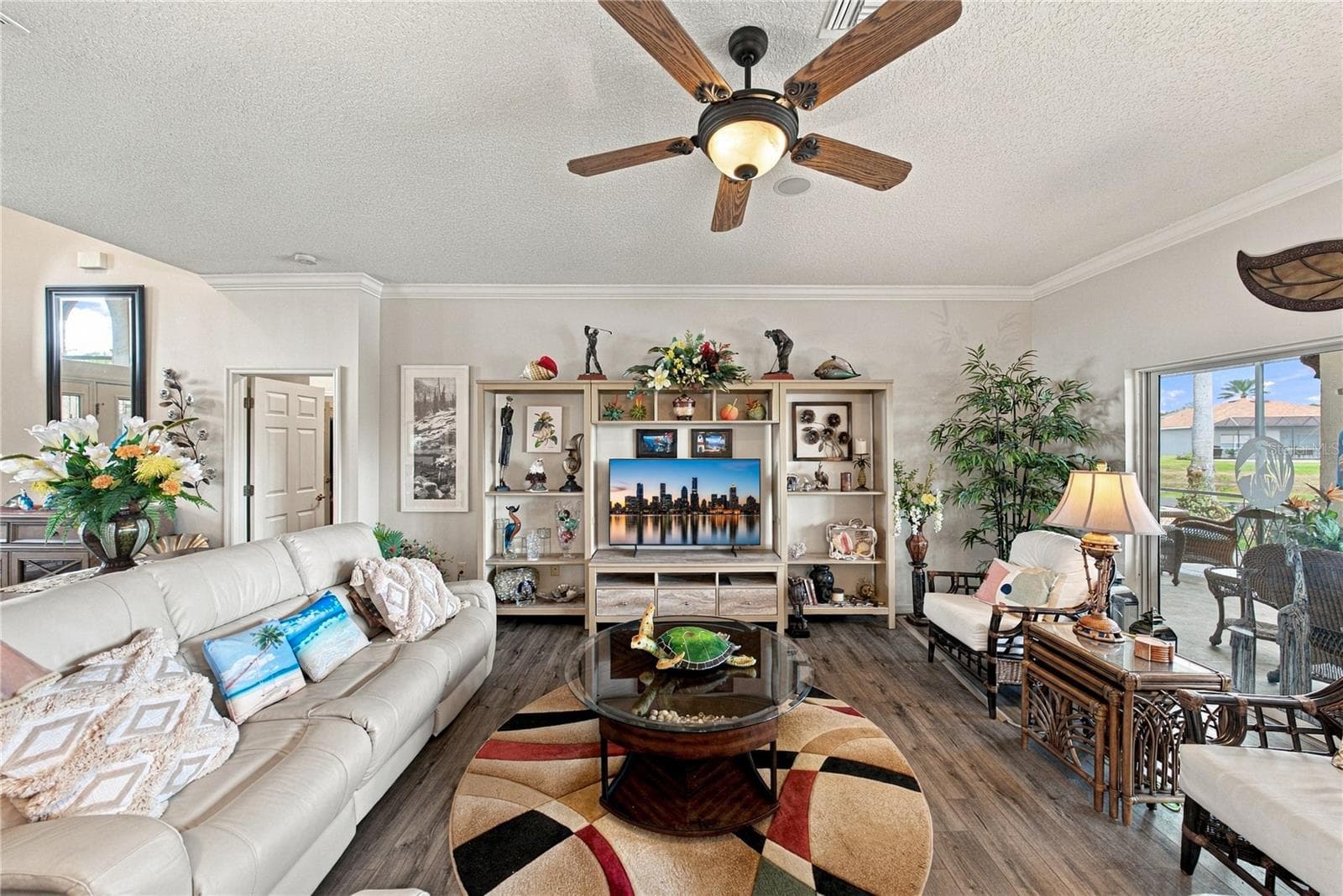 The living room has a designer ceiling fan with light. - 4232 DORNOCH DR, LAKE WALES