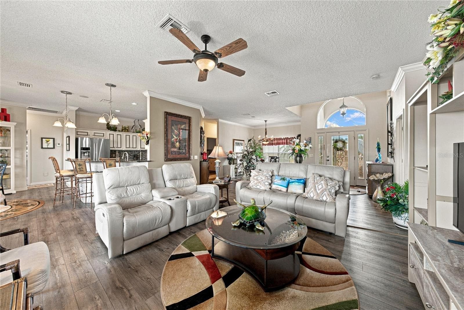 This view shows the relationship between the living room and the adjacent kitchen. - 4232 DORNOCH DR, LAKE WALES