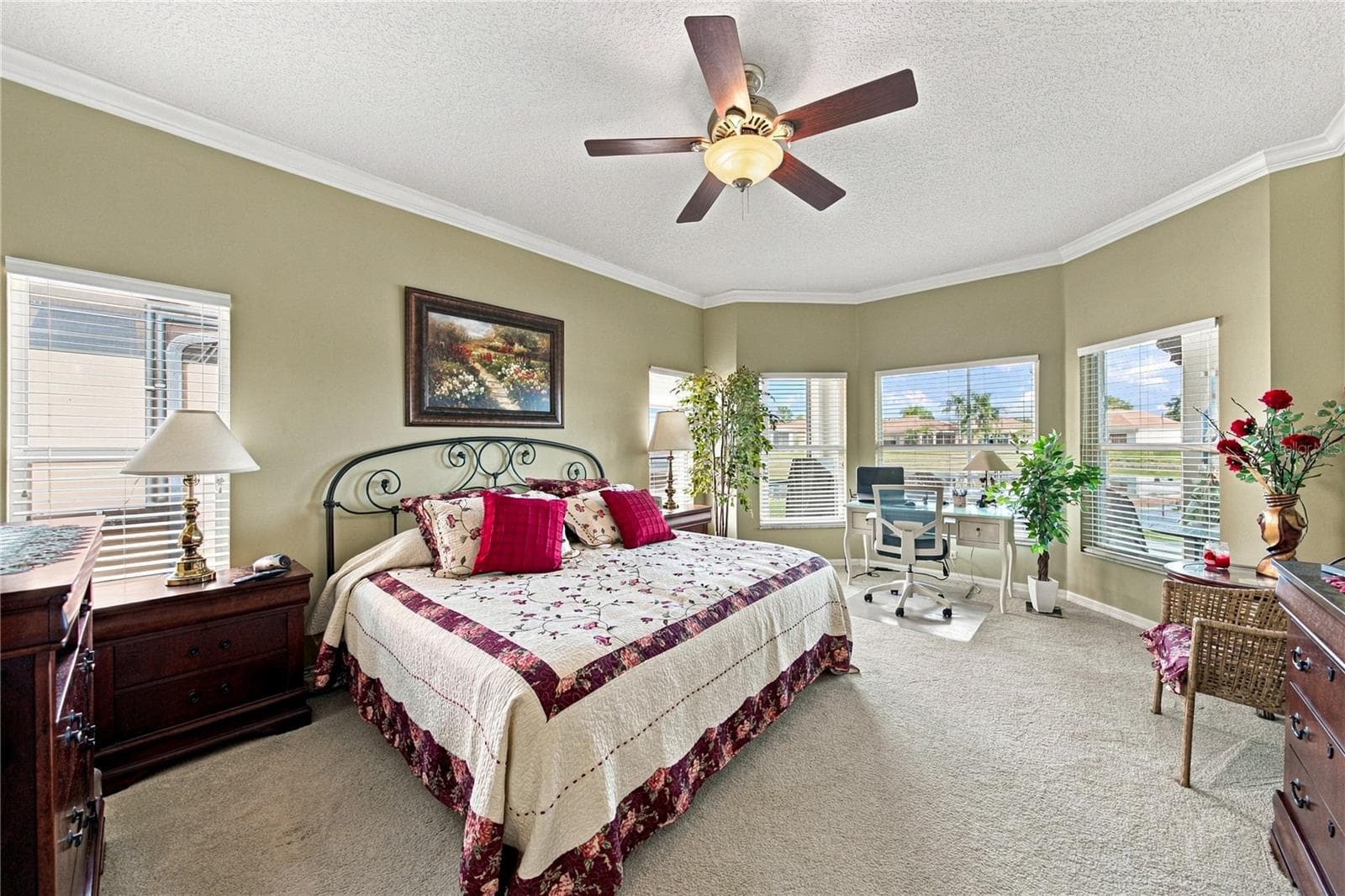 The primary suite fills the entire west wing. The primary bedroom has a bay window area. - 4232 DORNOCH DR, LAKE WALES