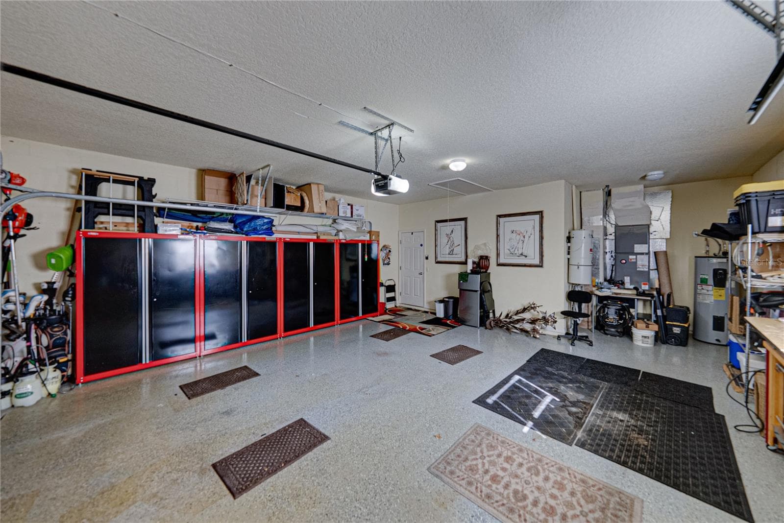 The alcove at the north end of the garage holds the whole house vacuum system. - 4232 DORNOCH DR, LAKE WALES