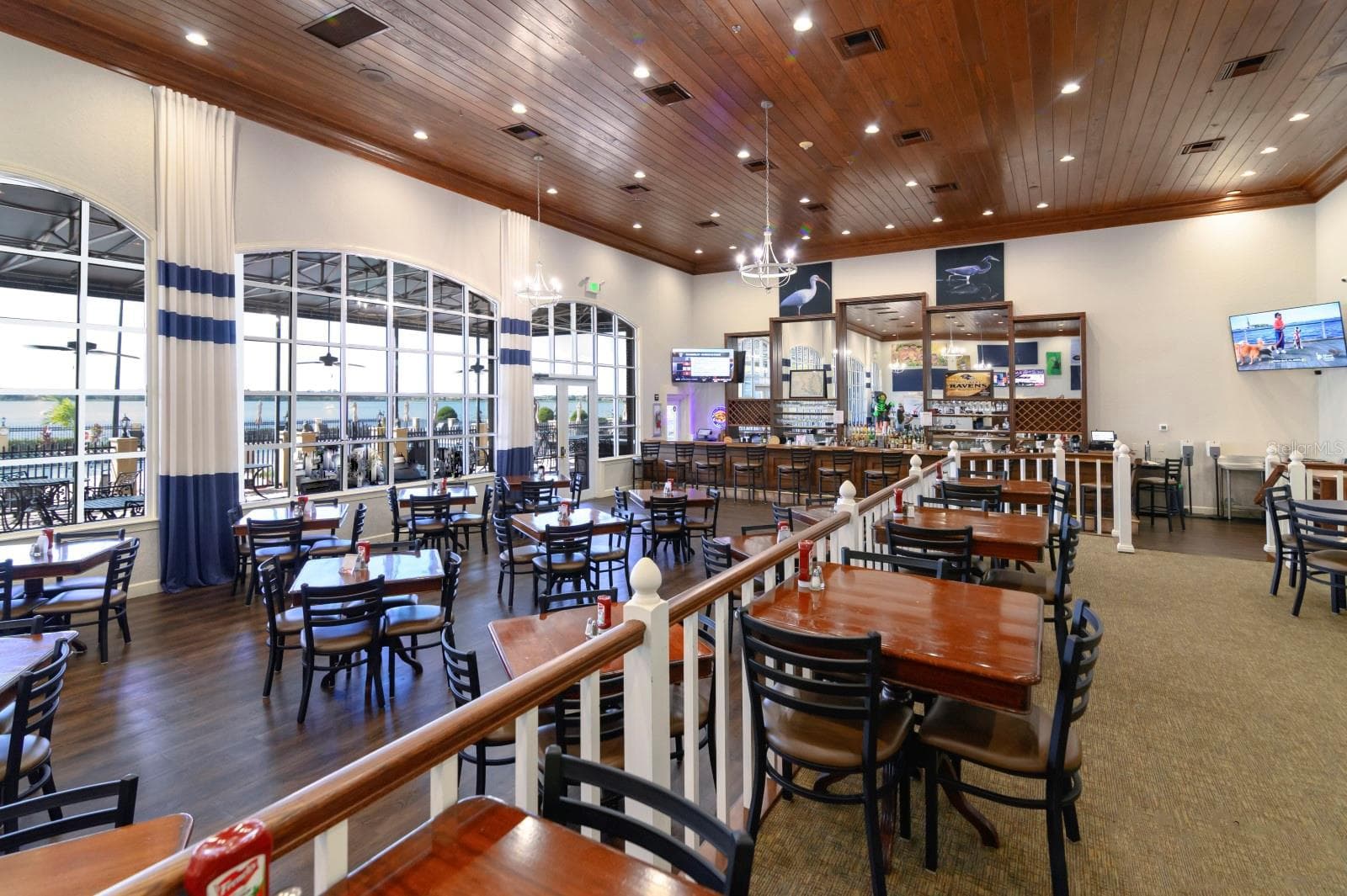 The main clubhouse has a full-service restaurant and bar with outdoor seating. - 4232 DORNOCH DR, LAKE WALES