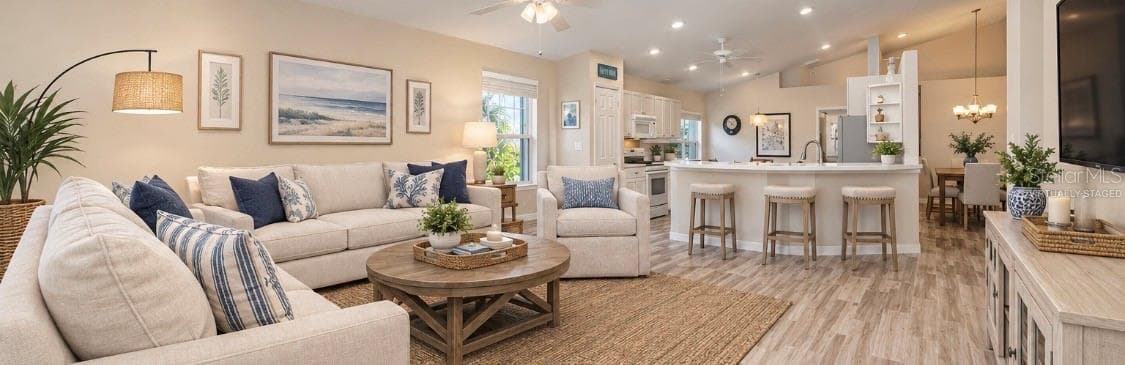 Virtually Staged Family room open to kitchen and kitchen cafe. - 5113 FLAGSTONE DR, SARASOTA