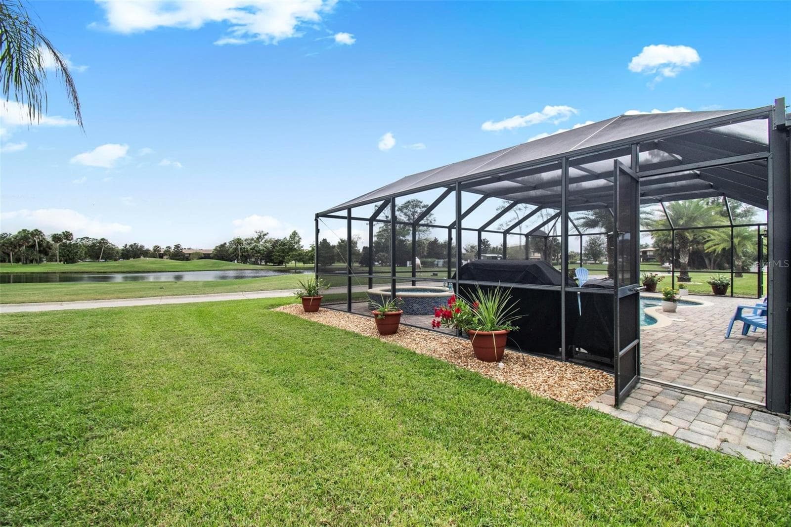 Lanai looking to pond and golf course - 8 COUNTRY CLUB HARBOR CIR, PALM COAST