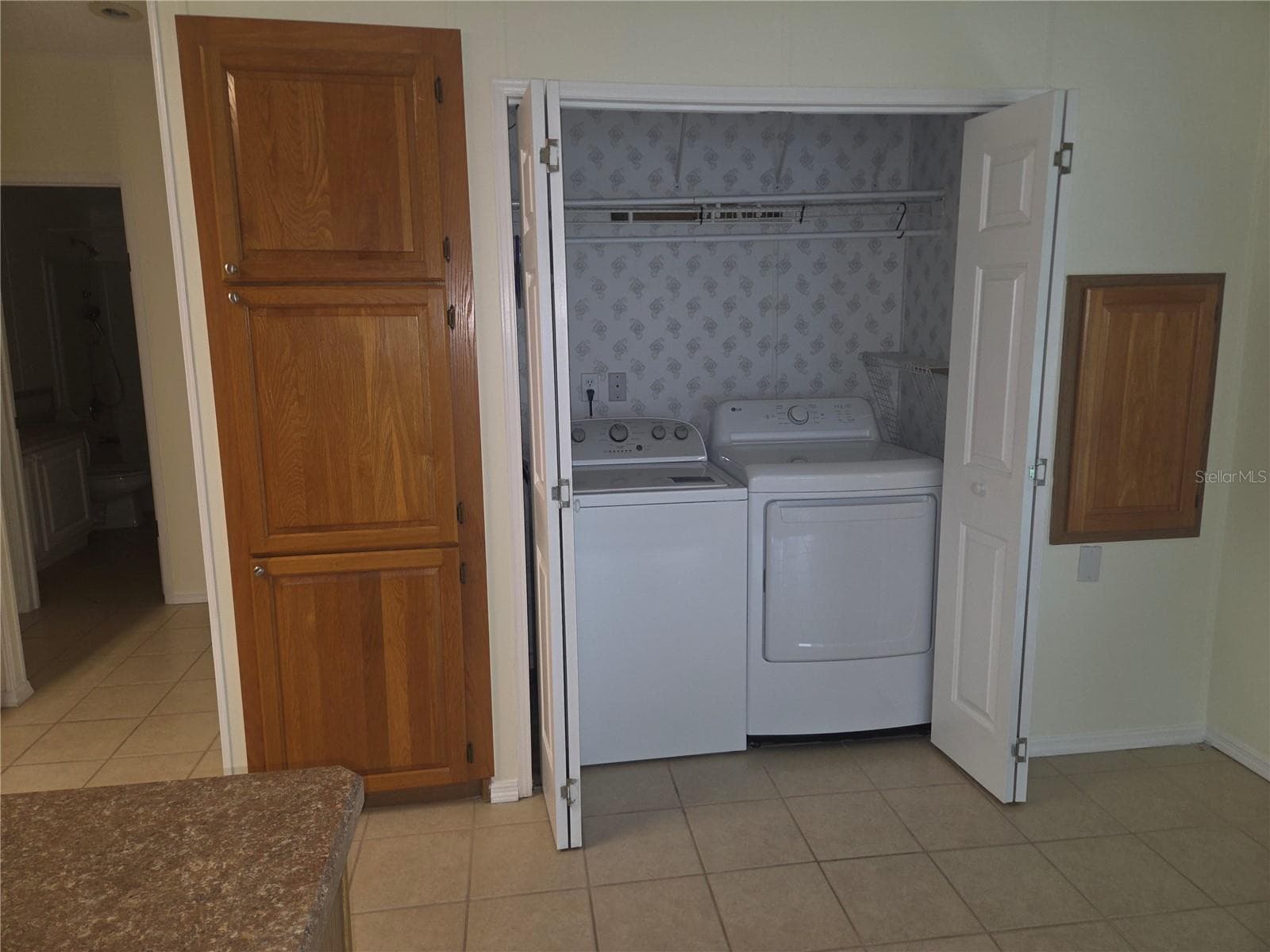 Kitchen dinnett area has washer and dryer tucked in here - 57 STRAPHMORE DR, HAINES CITY
