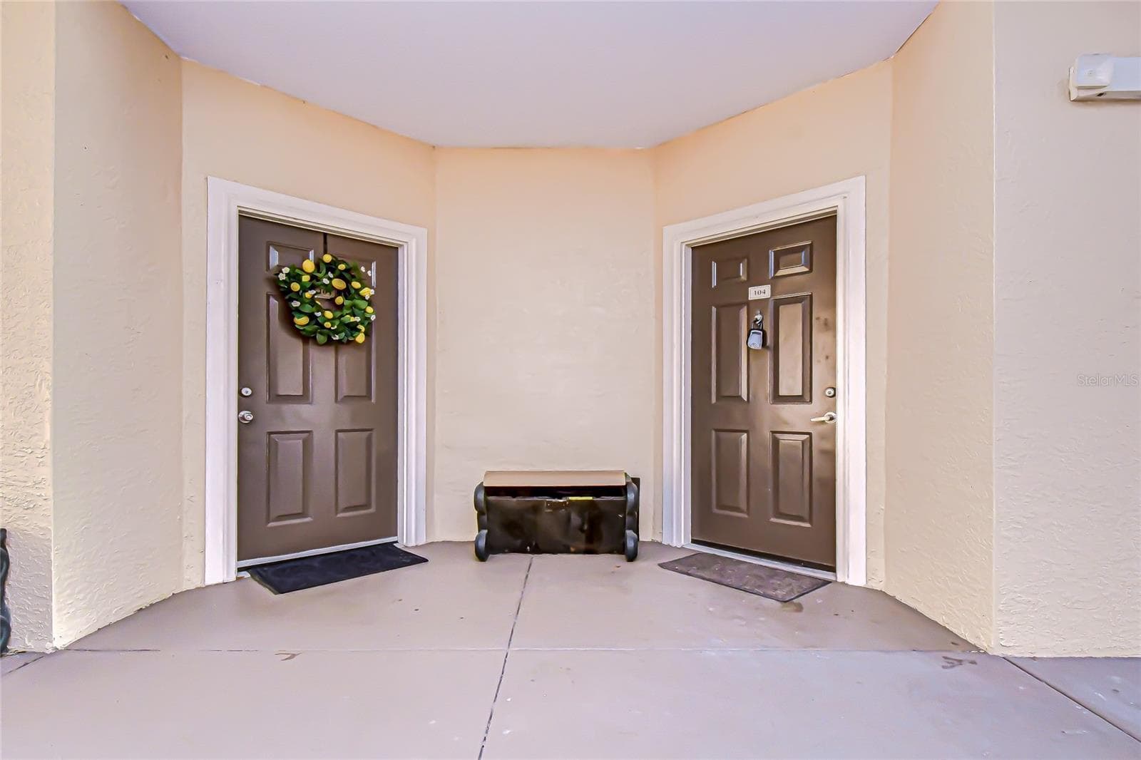 Welcoming exterior entry features dual front doors and neutral tones, providing a covered entryway and easy access into the home. - 5125 PALM SPRINGS BLVD #3104, TAMPA