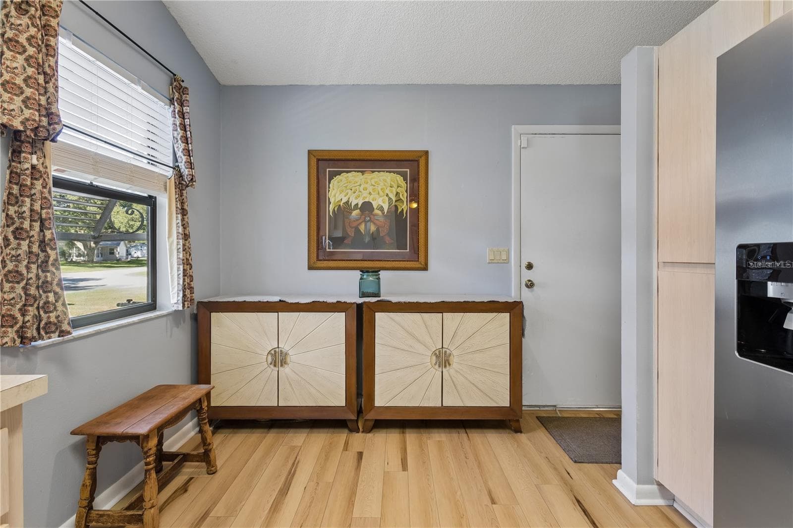 Entry from the living room into the kitchen. Door leads to the garage. - 803 DUNDEE CIR #803, LEESBURG