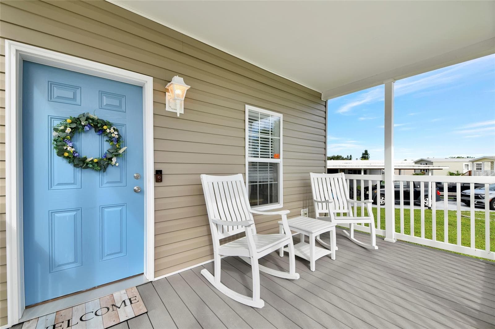 Beautiful covered porch complete with rocking chairs - 6843 HIKINA DR, NORTH PORT
