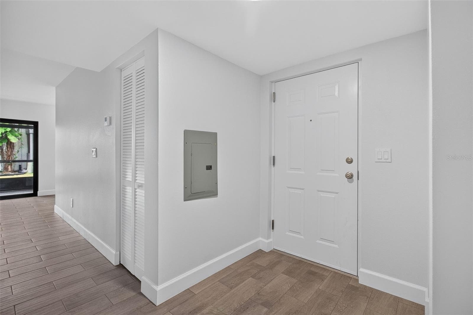 Foyer with new front door and newer electrical panel - 876 116TH AVE N #103, ST PETERSBURG