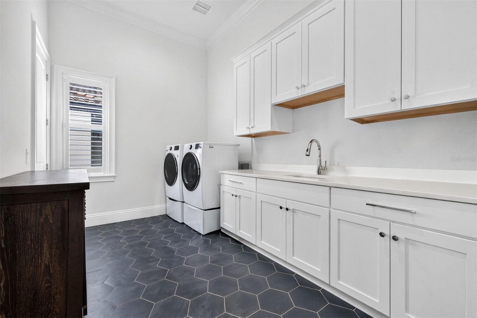 Thoughtfully Designed Laundry Room with Ample Cabinetry and Utility Sink - 1341 MONTEREY BLVD NE, ST PETERSBURG