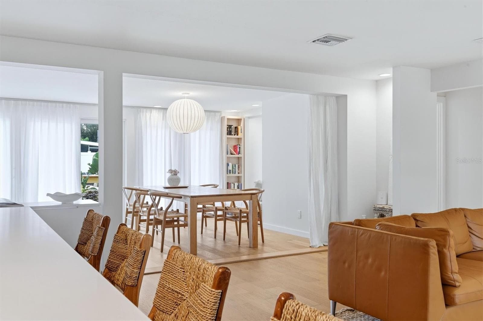 The area then flows from this point through to the dining room, highlighted by a built-in bookcase and accented by a magnificent Noguchi-Style Shoji Paper Light….. - 2513 CROTON AVE, SARASOTA