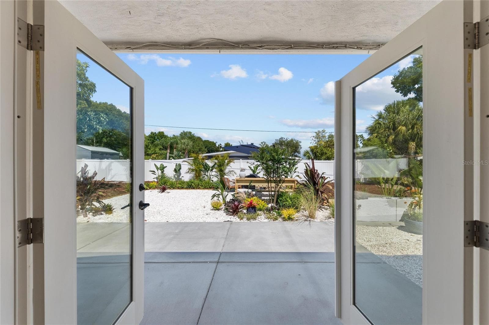 From this room, the inside spaces seamlessly connect with the outside, through window doors that fully open to the yard. - 2513 CROTON AVE, SARASOTA