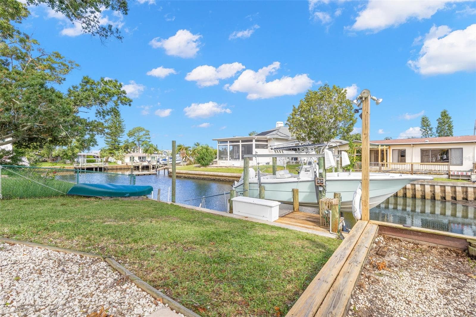 Boating starts in your own backyard, with canal frontage, private dockage, a boat lift, and direct access toward the Gulf—all just steps from the lawn. - 332 WESTWINDS DR, PALM HARBOR