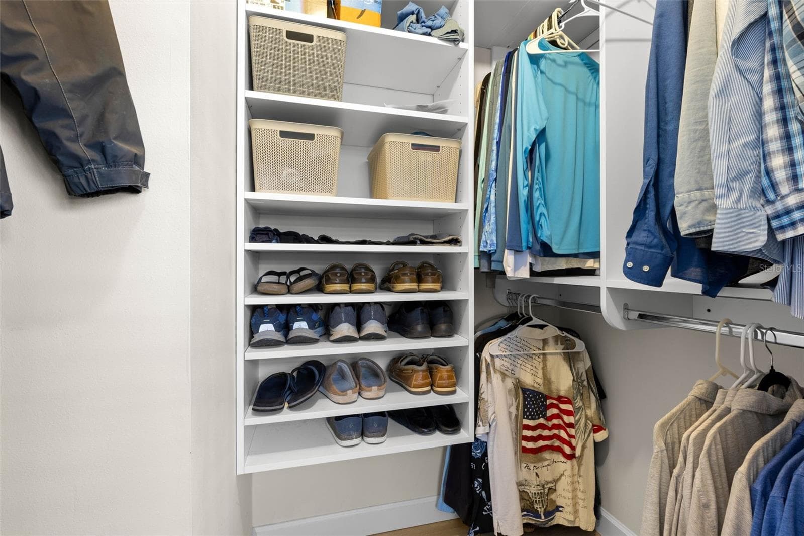 A well-organized walk-in closet in the primary suite offers built-in shelving, double hanging space, and plenty of room to keep clothing and accessories neatly arranged. - 332 WESTWINDS DR, PALM HARBOR